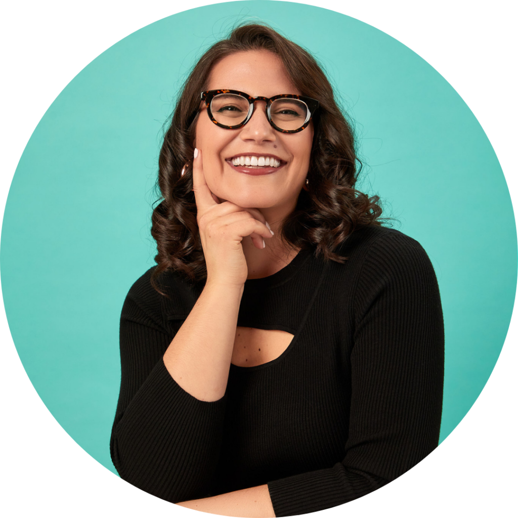 Danielle Bezalel, MPH wearing a black top, holds one hand up to her face and smiles