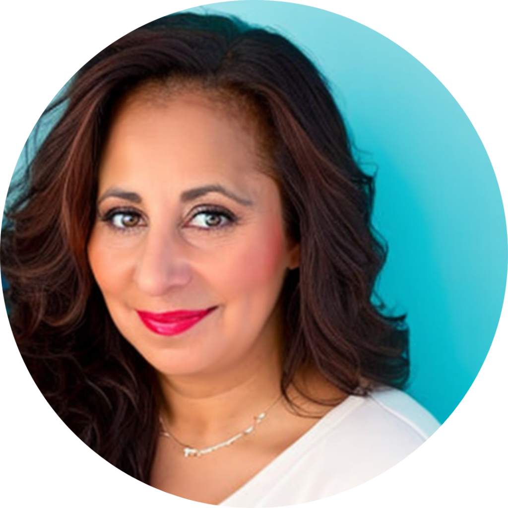 Julie DeLucca-Collins in red lipstick and a white top against a bright blue background