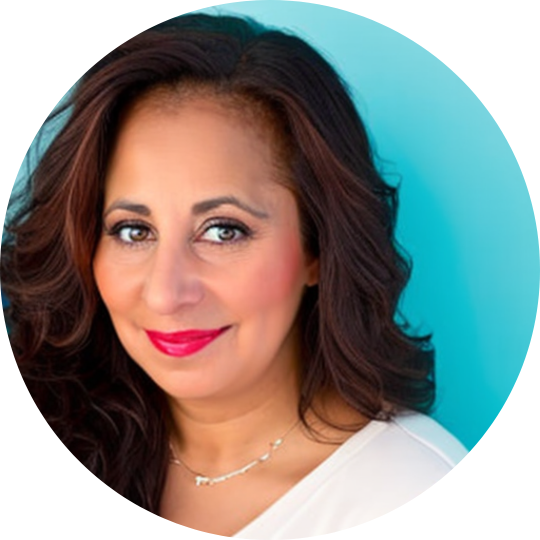 Julie DeLucca-Collins in red lipstick and a white top against a bright blue background