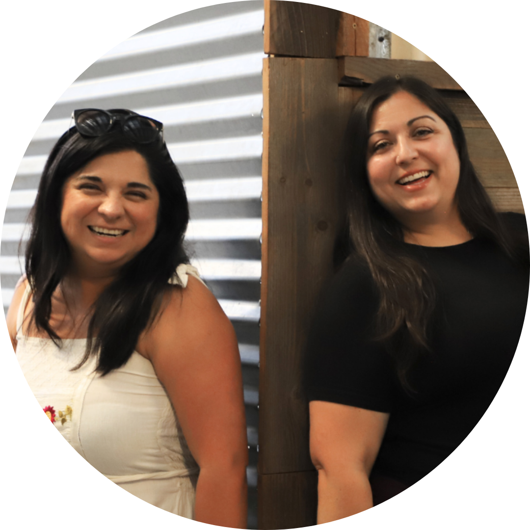 Nicole Moreno-Deinzer and Gisel Martín stand back to back smiling at the camera