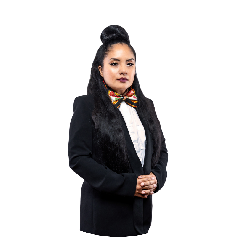 Elvira Zamora in a dark suit and colorful bow tie hands clasped in front of her