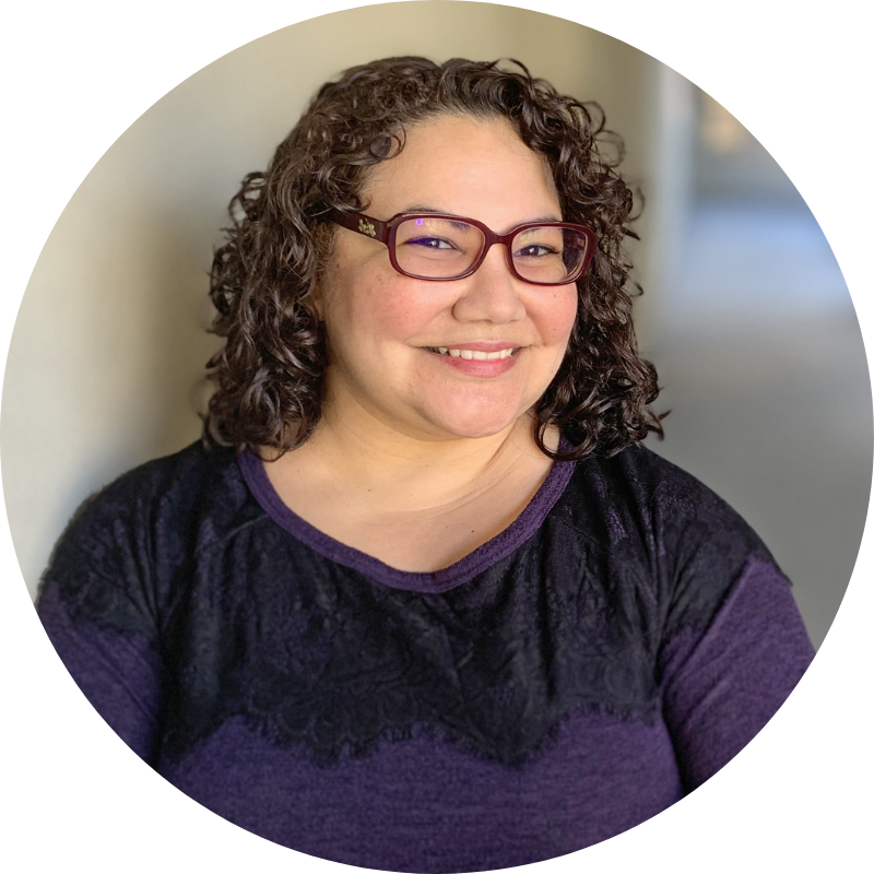 Paulette Erato in red glasses and purple sweater